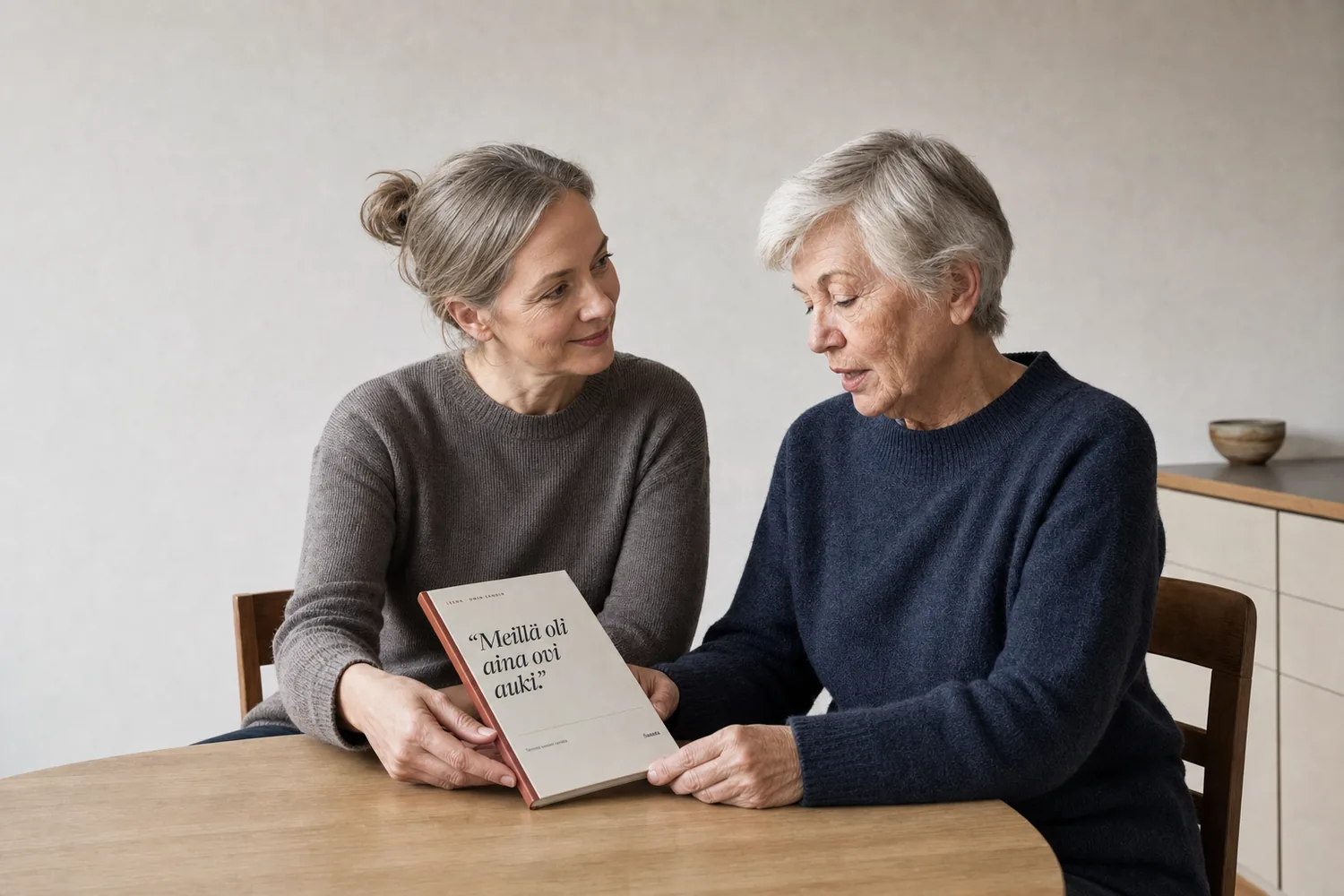 A mother and daughter with a Sanota book between them